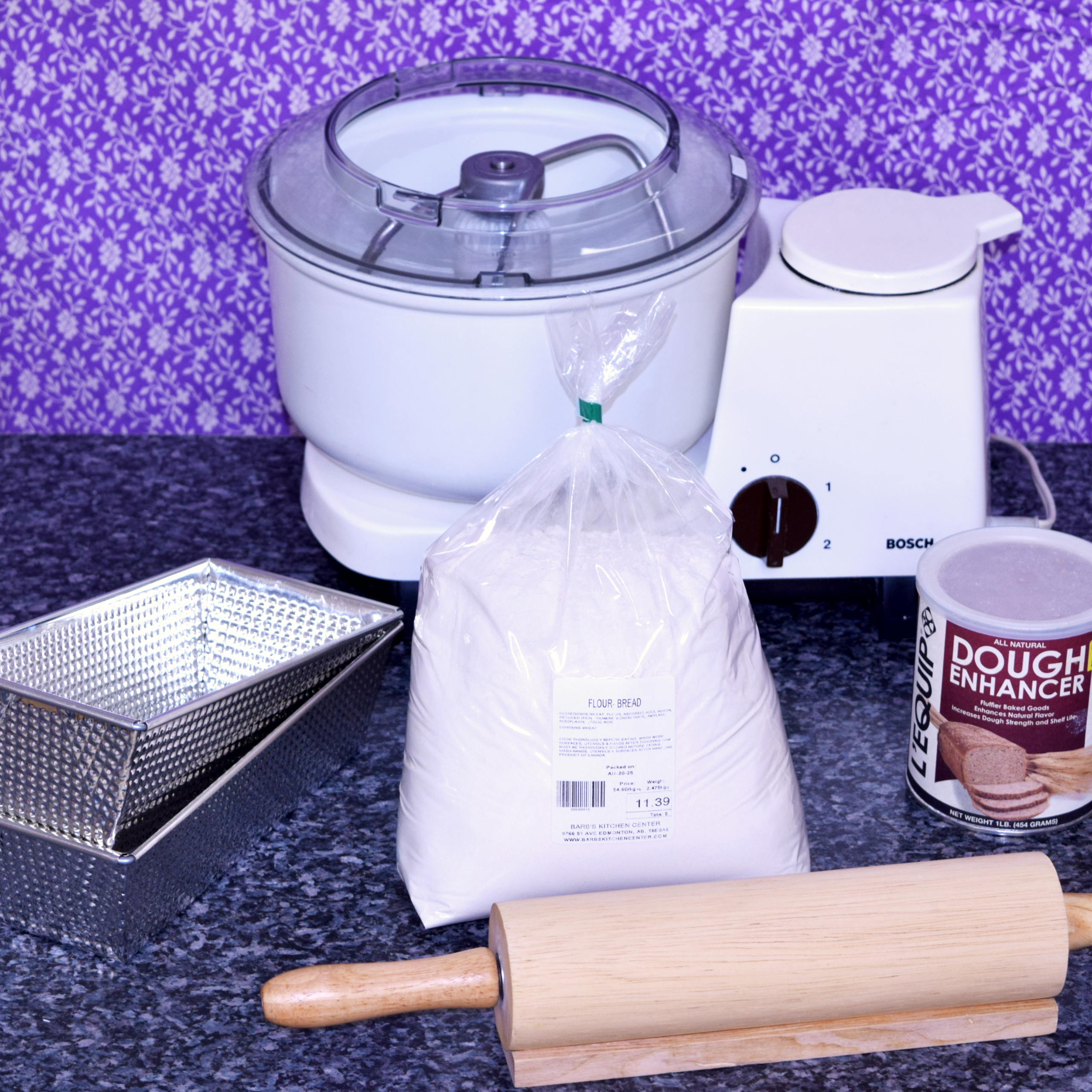 Photo of breadmaking supplies on a kitchen counter with a purple floral background